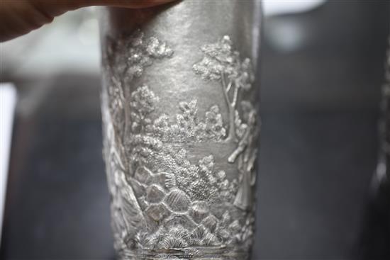 Two Indian white metal beakers, each embossed with scenes of women making offerings to Lord Shiva